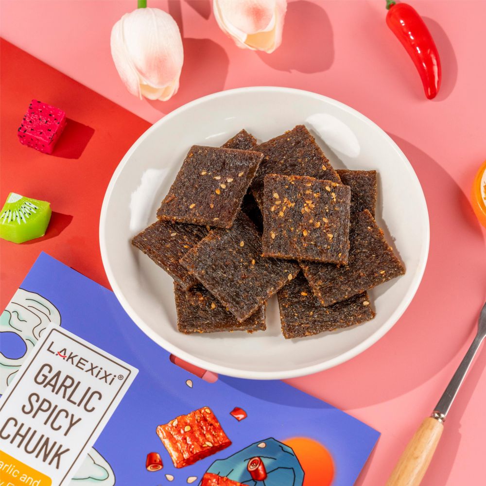 Close-up of Traditional Garlic Spicy Chunk texture - thick chewy grain snack, Garlic Spicy flavor, vacuum-packed