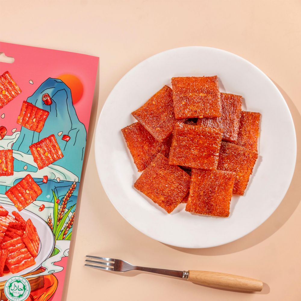 	Close-up of Traditional Sweet Spicy Chunk texture - thick chewy grain snack, Sweet Spicy flavor, vacuum-packed